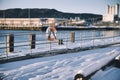 Buyo hanging on a metallic railing near a pathway fully covered in snow Royalty Free Stock Photo
