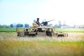Romanian soldiers man a Humvee armored vehicle on a field, on a sunny summer day during a drill