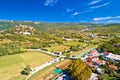 Buzet. Hill town of Buzet and Mirna river in green landscape aerial view