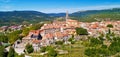 Buzet. Hill town of Buzet surrounded by stone walls in green landscape aerial panoramic view