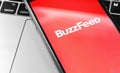 BuzzFeed logo on the display smartphone. BuzzFeed is an online media news company