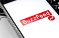 BuzzFeed logo on the screen smartphone. BuzzFeed is an online media news company