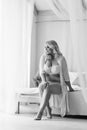 Bw blonde girl plus size sitting on the bed in white lingerie portrait of Bali morning bride Royalty Free Stock Photo