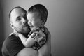 BW portrait of father playing with his daughter.