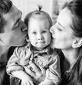 BW portrait of mother and father kissing his year-old daughter Royalty Free Stock Photo