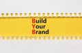 BYB build your brand symbol. Concept words BYB build your brand on white paper on a beautiful yellow background. Business and BYB Royalty Free Stock Photo