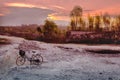 Bycicle stands on field when sunset, bukit jeddih, bangkalan, madura island, Indonesia Royalty Free Stock Photo