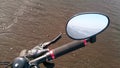 Bycycle parked on the beach. Mirror has sea view.