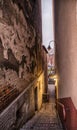 Bydgoszcz, Poland, Colourful facade of old historical tenement house. very narrow street and lamp light on stairs. Royalty Free Stock Photo