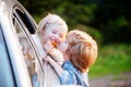 Bye bye. Little boy say good bye with little girl. Farewell concept. Gives warm kiss. Couple saying goodbye before car Royalty Free Stock Photo