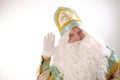 saint nicholas waving bye bye Sinterklaas portrait gold with blue headdress lush beard and white mustache white gloves Royalty Free Stock Photo