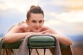 Bye bye stress. Portrait of a young woman relaxing on a massage table outside. Royalty Free Stock Photo