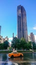 Taxi cab in New York Avenue with a beautiful skyscraper view in front and blue sky