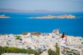 BYoung lady relaxing on the edge of swimming pool with beautiful view of amazing greek village Royalty Free Stock Photo