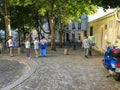 Bystanders watch plein air artist in Paris