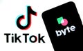 Byte app on the silhouette of smartphone and TikTok logo on a blurred background screen. Byte is the sequel to Vine app. Real phot