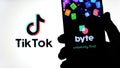 Byte app on the silhouette of smartphone and TikTok logo on a blurred background screen. Byte is the sequel to Vine app. Real phot