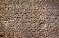 Byzantine patterned ornament carved in stone wall, ancient texture background, detail of interior with geometric relief