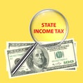 state income tax under magnifier glass on yellow Royalty Free Stock Photo