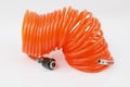 A isolated orange compressed air-hose on white ground Royalty Free Stock Photo