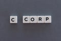 C corp word made of square letter word on grey background