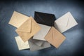 C6 envelopes, brown, gray, and black, flying