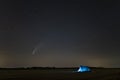 C / 2020 F3 comet NEOWISE in the evening sky. Camping under the starry sky, where there is a bright comet and a tail between the Royalty Free Stock Photo