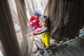 Ca Mau, Vietnam - Dec 6, 2016: Fisher family with the daughter playing near her mother mending casting net in Ngoc Hien, Ca Mau Royalty Free Stock Photo