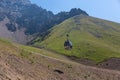 The cab of a cable car rises to the top of the mountain