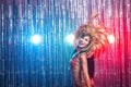 Cabaret, dancer and holidays concept - Cute young girl in bright colorful carnival costume on dark background Royalty Free Stock Photo