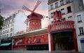 Cabaret Moulin Rouge in a sunset day at Montmartre, Paris, France. Moulin Rouge is a famous cabaret built in 1889