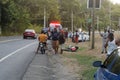 Motorcycle accident broken and wrecked lie on grass near road.