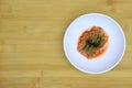 Cabbage Kimchi in a White Round Bowl on the wooden background, top view, Korean food , selective focus,