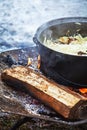 Cabbage with meat cooking in a cauldron on open fire Royalty Free Stock Photo