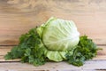 Cabbage and parsley on wooden background.