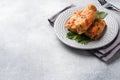 Cabbage rolls with beef, rice and vegetables on the plate. Stuffed cabbage leaves with meat. Gray concrete table Copy space