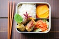 cabbage rolls packed for lunch in a bento box with salad