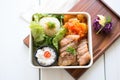 cabbage rolls packed for lunch in a bento box with salad