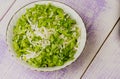 Cabbage salad in a plate on a wooden table.