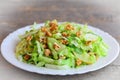 Cabbage slaw with pear and walnuts. Quick pear and cabbage slaw on a plate. Vitamin rich food