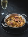 Cabbage soup in silver bowl and glass of white wine on dark back Royalty Free Stock Photo