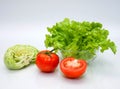 Cabbage tomatoes and salad in bowl on white background.