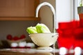 Cabbage in a washing bowl over kitchen counter