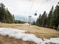 Cabin above grassy ski slope moving up to hill with tourist Royalty Free Stock Photo