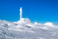 A cabin with an antenna completely covered by snow and ice on the snowy top of ÃÂ reskutan on a sunny day with blue skies in ÃÂ re