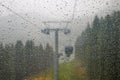 Cabin of Cable car lift arrive to top of the mountain with place of rest, restaurant and hotel in foggy day. Dolomites, Italy Royalty Free Stock Photo