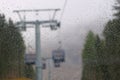 Cabin of Cable car lift arrive to top of the mountain with place of rest, restaurant and hotel in foggy day. Dolomites, Italy Royalty Free Stock Photo