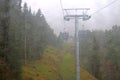 Cabin of Cable car lift arrive to top of the mountain with place of rest, restaurant and hotel in foggy day. Dolomites, Italy Royalty Free Stock Photo