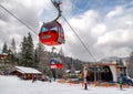 Cabin of cableway and skiers on slope at resort Hrabovo, Slovakia