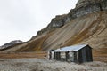 Cabin and cliffs in Skansbukta, Svalbard Royalty Free Stock Photo